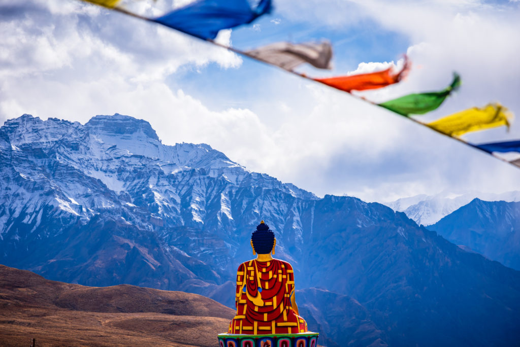 Buddha statue overlooking the valley at Langza village kaza, Spiti, Himachal Pradesh, India.